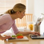 female cooking and looking up recepies online in kitchen